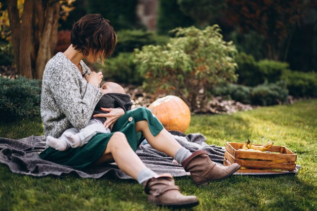 Mother with her little son having picnic on a back yard