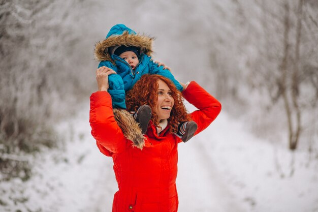 Mother with her little son together in a winter park