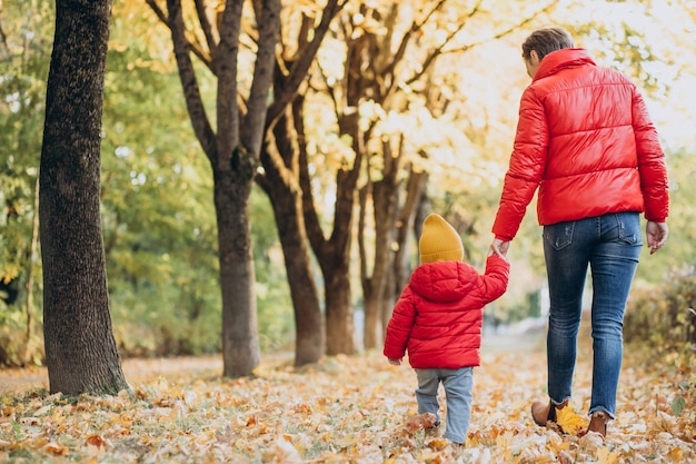 Mother with little baby son in autumn park