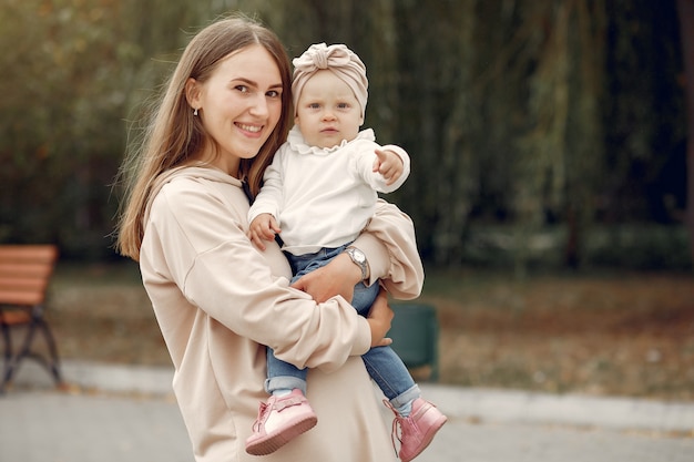 Mother with little child spend time in a park