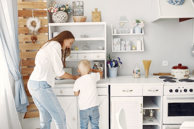 Free photo mother with little children cooking at home