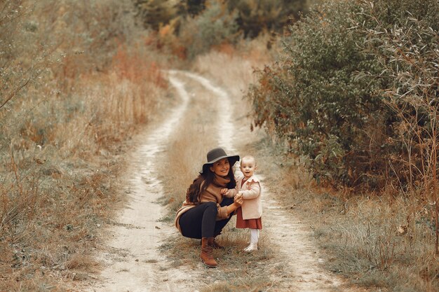 Mother with little daughter playing in a field