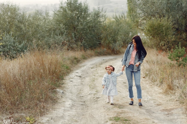 Mother with little daughter playing in a field