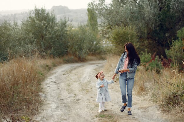 Mother with little daughter playing in a field