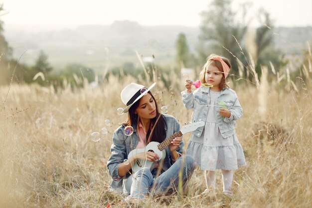 Mother with little daughter playing in a field