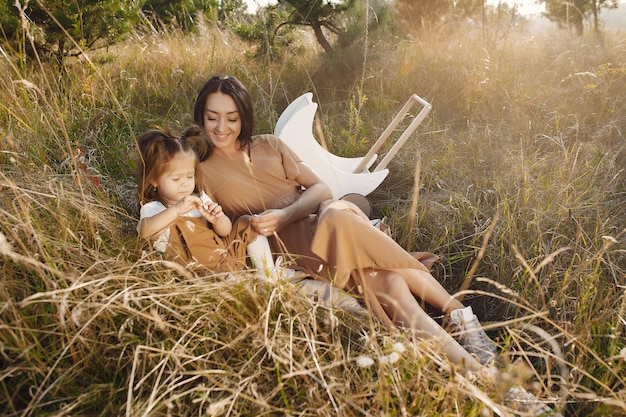 Free Photo mother with little daughter playing in a summer field