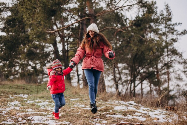 Mother with little daughter in a winter forest