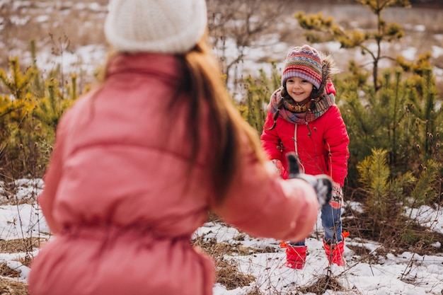 Free photo mother with little daughter in a winter forest