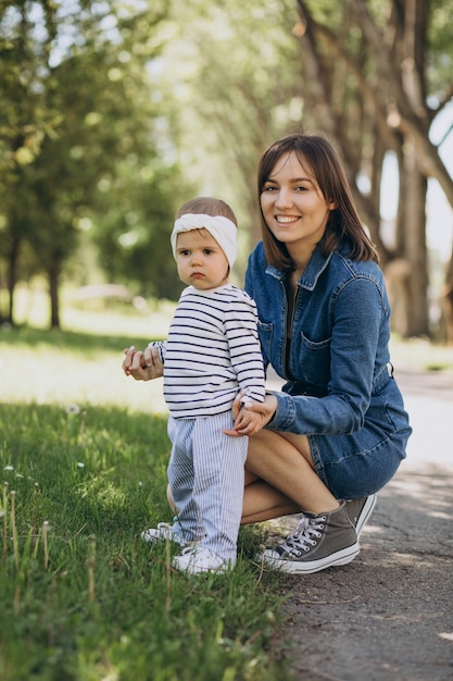 Mother with little girl playing in park