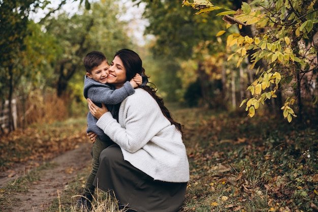 Mother with little son in an autumn park