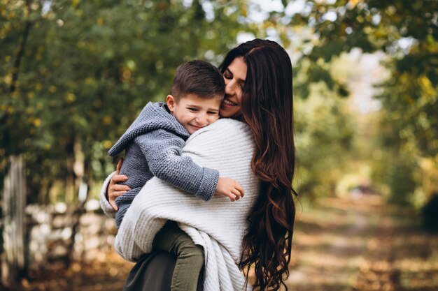 Mother with little son in an autumn park