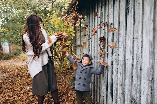 Mother with little son in an autumn park