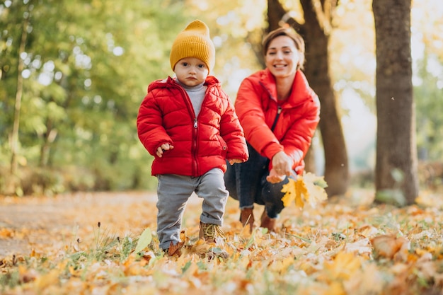 Mother with little son in autumn park