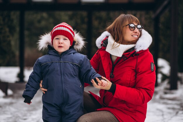 Mother with little son outside in winter