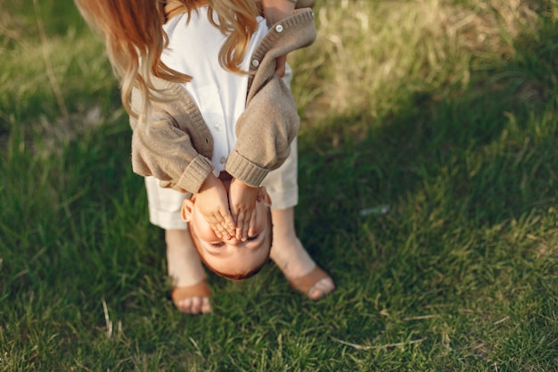 Free photo mother with little son playing in a summer field