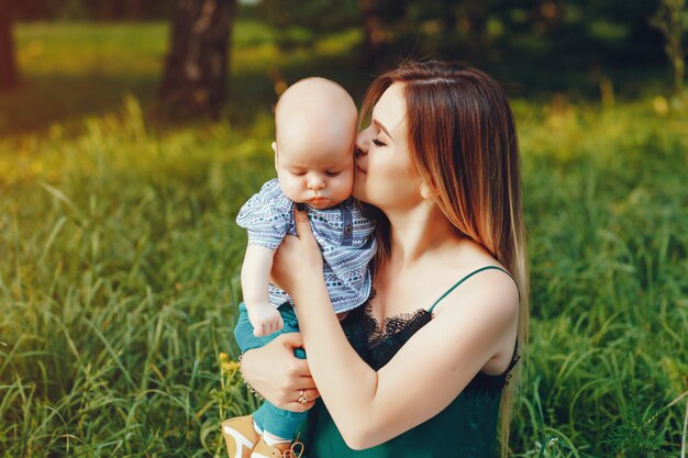 Mother with little son playing in a summer park