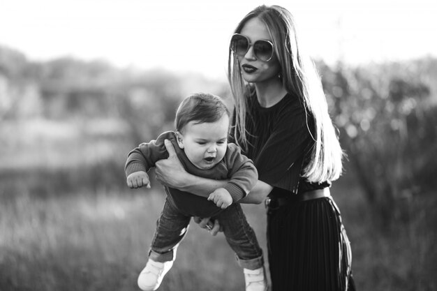 Mother with little son together in park