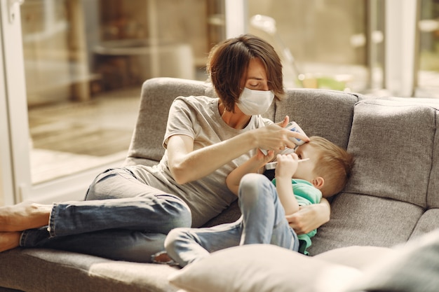 Mother with littler son sitting at home on quarantine