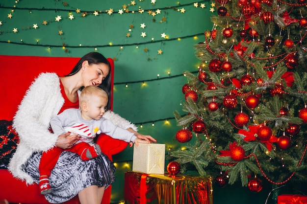 Mother with son by the Christmas tree