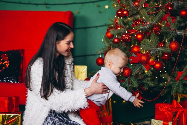 Mother with son by the Christmas tree