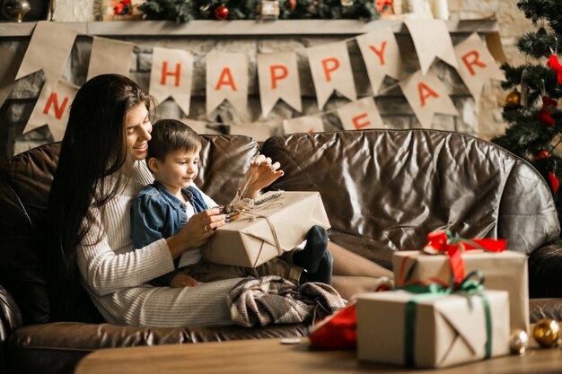 Mother with son on Christmas with presents