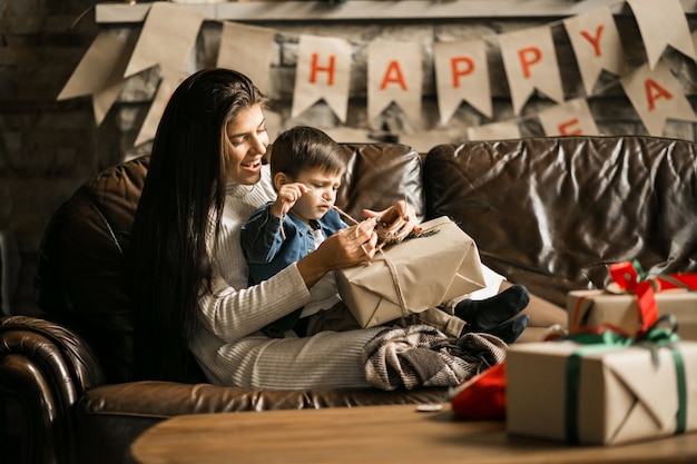 Mother with son on Christmas with presents