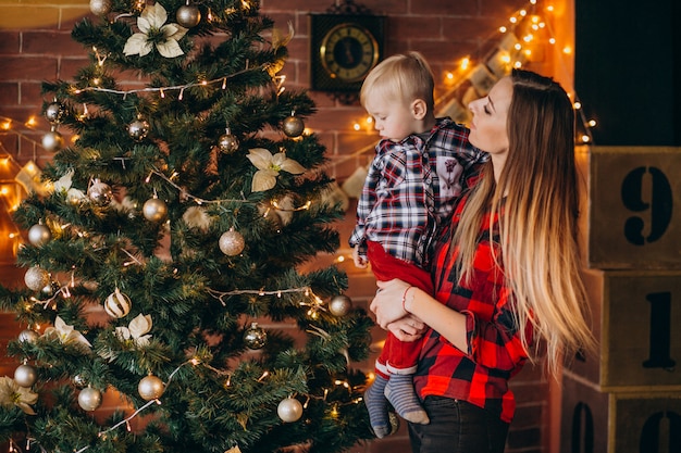 Mother with son decorating christmas tree