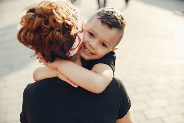 Free photo mother with son playing in a summer city