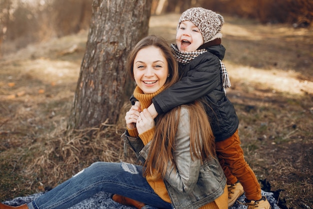 Free photo mother with son playing in a summer park