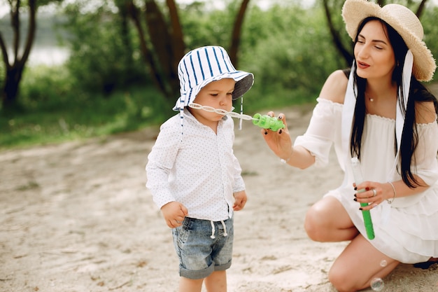 Mother with son playing in a summer park