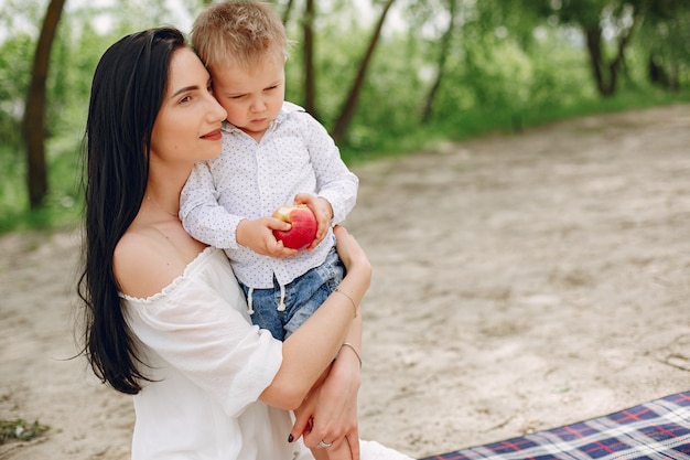 Mother with son playing in a summer park