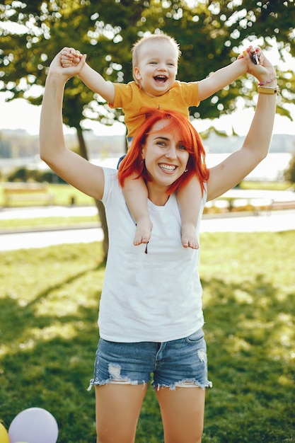 Free photo mother with son playing in a summer park