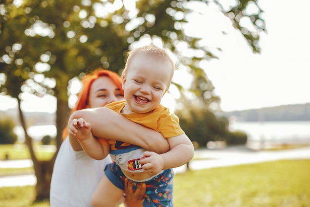 Free Photo mother with son playing in a summer park