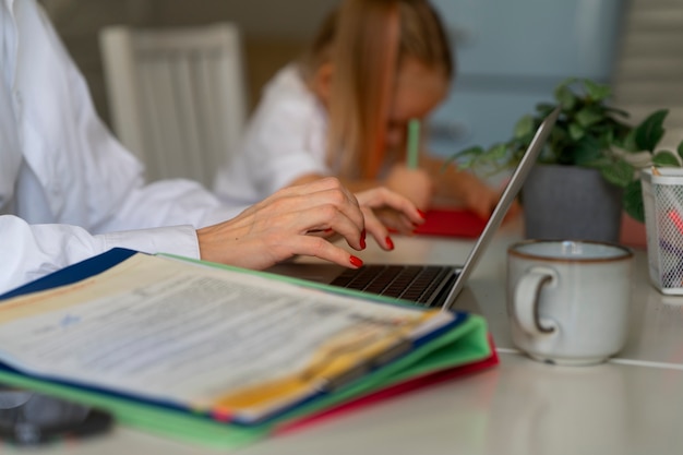 Free photo mother working from home trying to balance family life with child and job