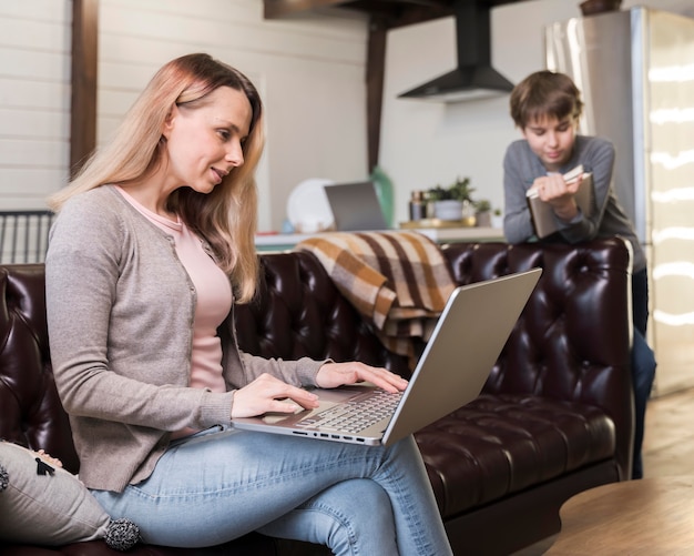 Mother working remotely on the couch