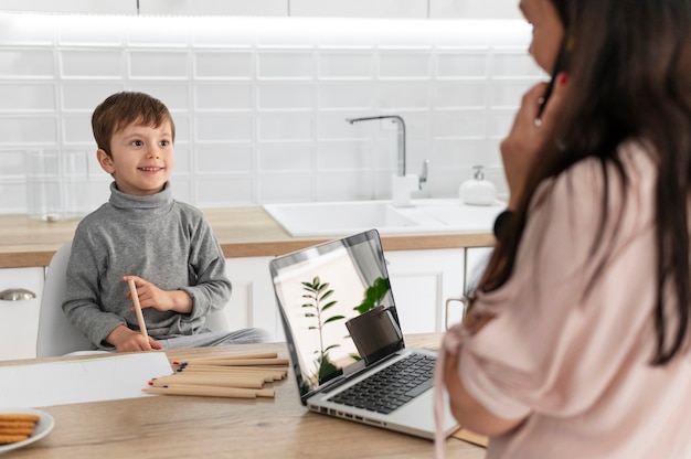 Mother working with laptop close up