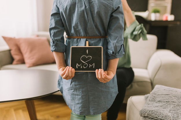 Mothers day concept with kid hiding slate