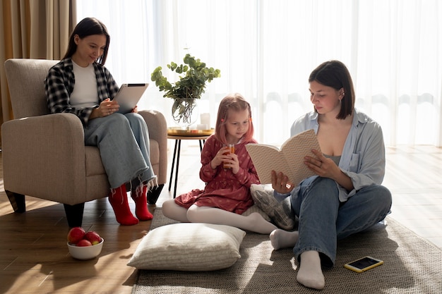 Mothers spending time together with their daughter indoors