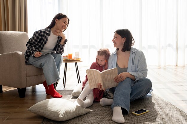 Mothers spending time together with their daughter indoors