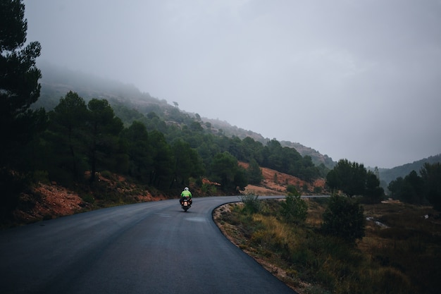 Motorcycle rider on empty country road