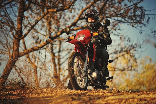 Motorcycle rider stay at sunset with him enduro bike