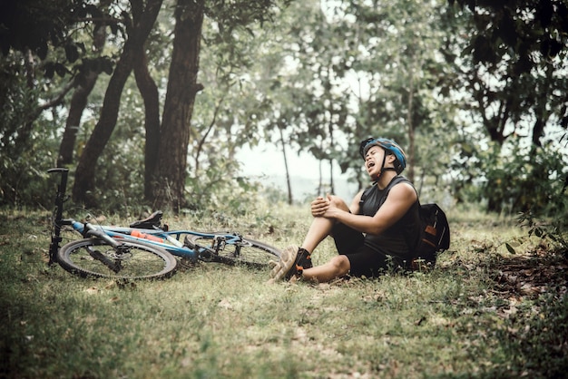 Free photo mountain bikers riding bike in autumn season among trees