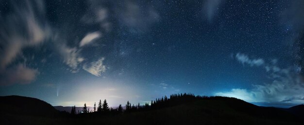 Mountain forest under beautiful night sky with stars