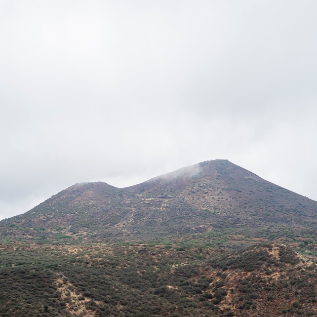 Free photo mountain peak in a cloudy day