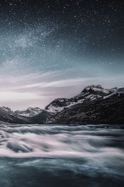 Free photo mountain under starry sky