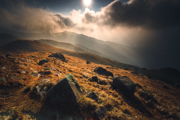 Mountain with stones and a shining sun during the sunrise