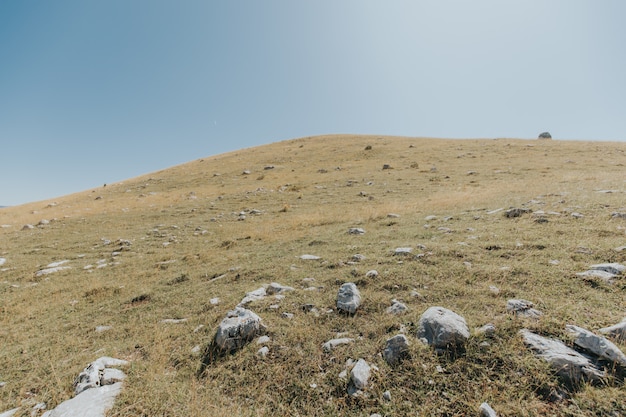 Mountains and hills with a lot of rocks under the beautiful blue sky