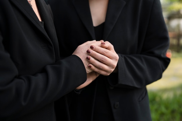 Mourning mother and daughter at a grave in the cemetery