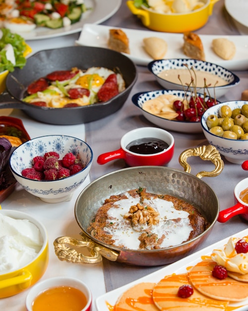 Mouthwatering traditional azerbaijani breakfast with kookoo, sausage and egg, pancake, salad