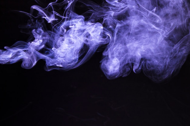 Free photo movement of soft purple smoke on black background